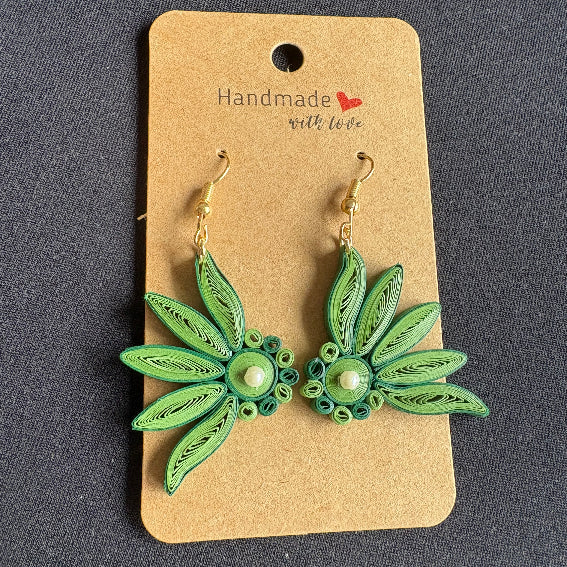 Green floral earrings on a 'Handmade with Love' card against a dark background