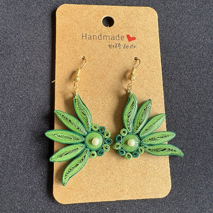 Green floral earrings on a 'Handmade with Love' card against a dark background