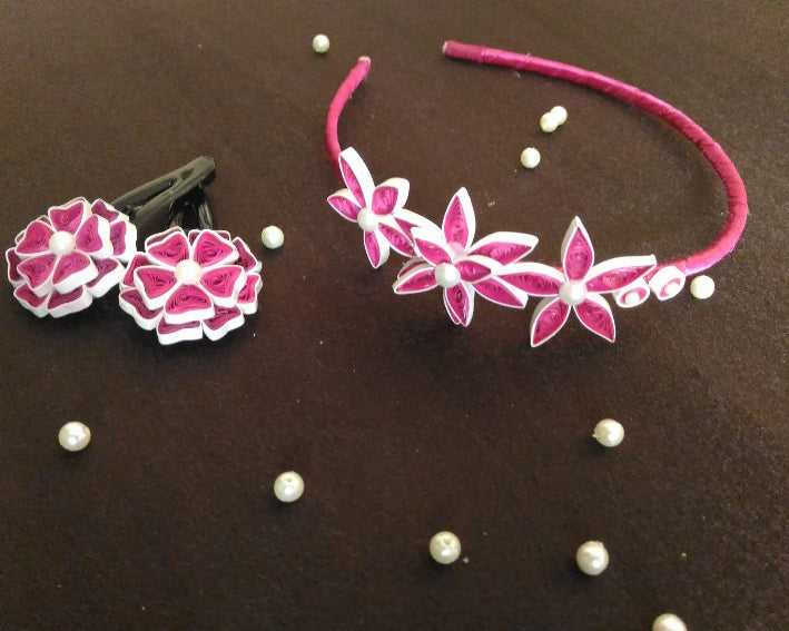 Floral headband and earrings with pink flowers and white beads on a brown background